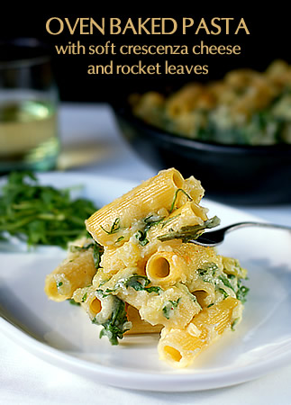 Oven baked pasta with crescenza cheese and rocket leaves